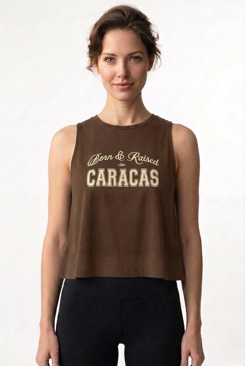 Woman wearing a brown sleeveless top with 'Born & Raised in Caracas' text on a white background